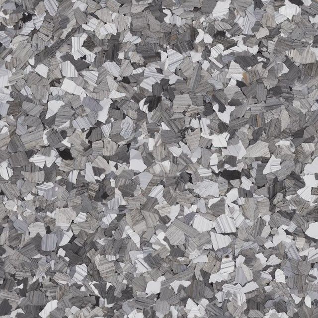 A surface texture featuring a dense, random mix of gray, white, and black vinyl decorative flakes.