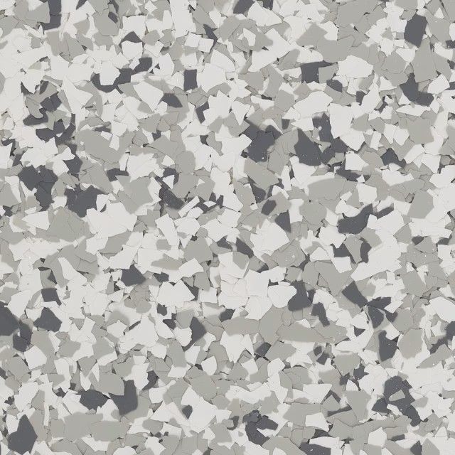 A seamless, speckled flooring pattern featuring a mix of white, light gray, and dark charcoal flakes.