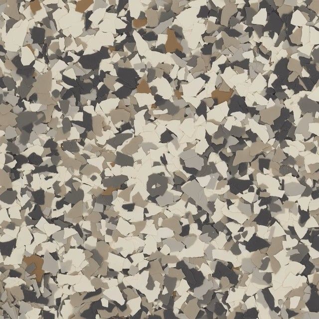 A close-up of a decorative epoxy floor finish with a multi-colored flake pattern in shades of beige, gray, and brown.