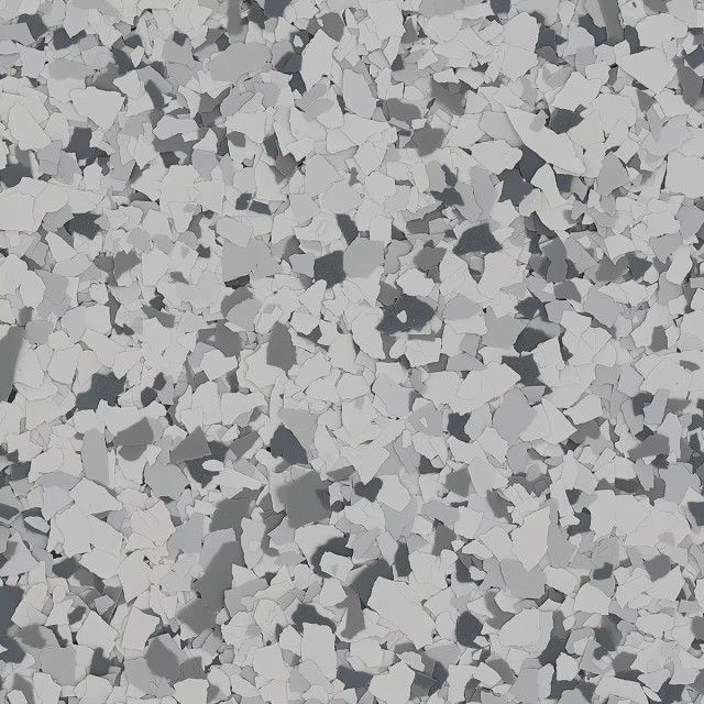 A close-up view of a floor coating with a speckled pattern of black, gray, and white vinyl chips.