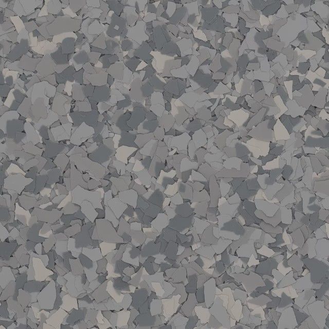 A textured floor surface covered in a mix of grey, light grey, and dark grey decorative vinyl paint flakes.