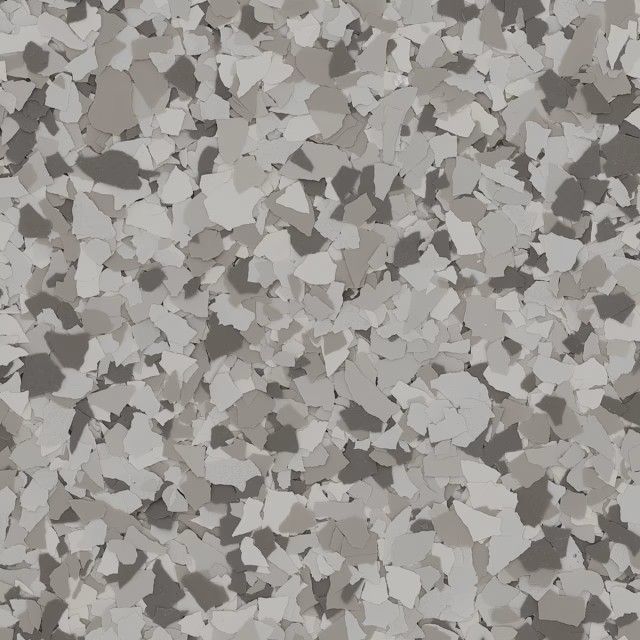 A close-up of a decorative flooring finish featuring a scattered, speckled pattern of white, gray, and dark charcoal chips.
