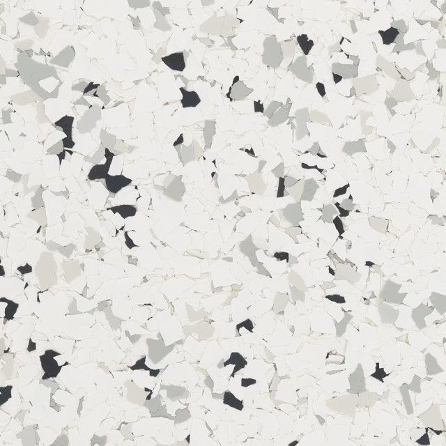 A close-up view of a decorative floor surface featuring a white base with flecks of black, gray, and light beige.