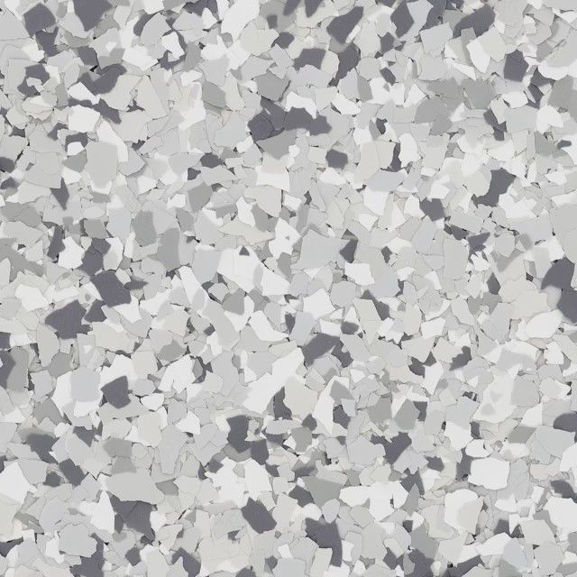 A close-up of a decorative epoxy floor coating featuring a speckled pattern of white, light gray, and dark gray vinyl chips.