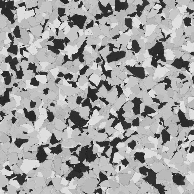 A close-up of a speckled floor texture featuring irregular black, white, and gray flakes against a neutral background.
