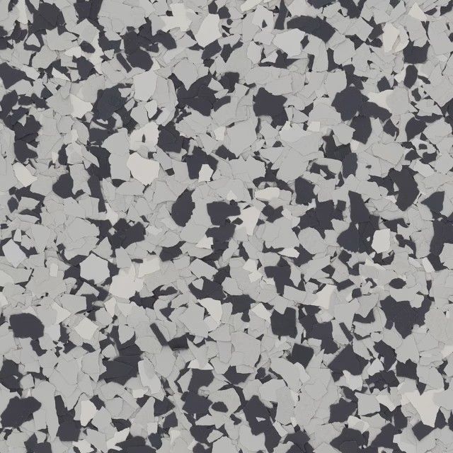 A decorative floor finish featuring a scattered, multi-colored pattern of small light gray, dark gray, and white flakes.
