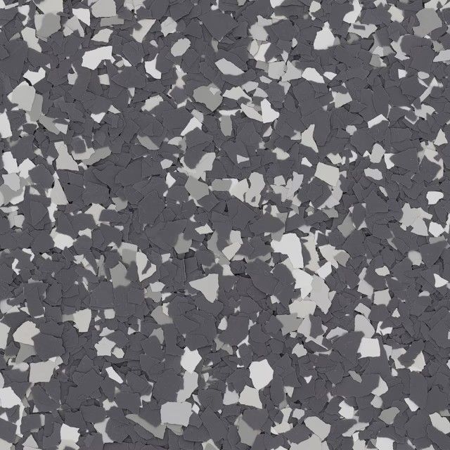 A high-angle view of a floor surface featuring a mix of dark charcoal, medium gray, and white vinyl paint chips.