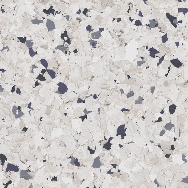 A close-up of a speckled floor texture featuring a mix of white, beige, light gray, and dark charcoal vinyl flakes.