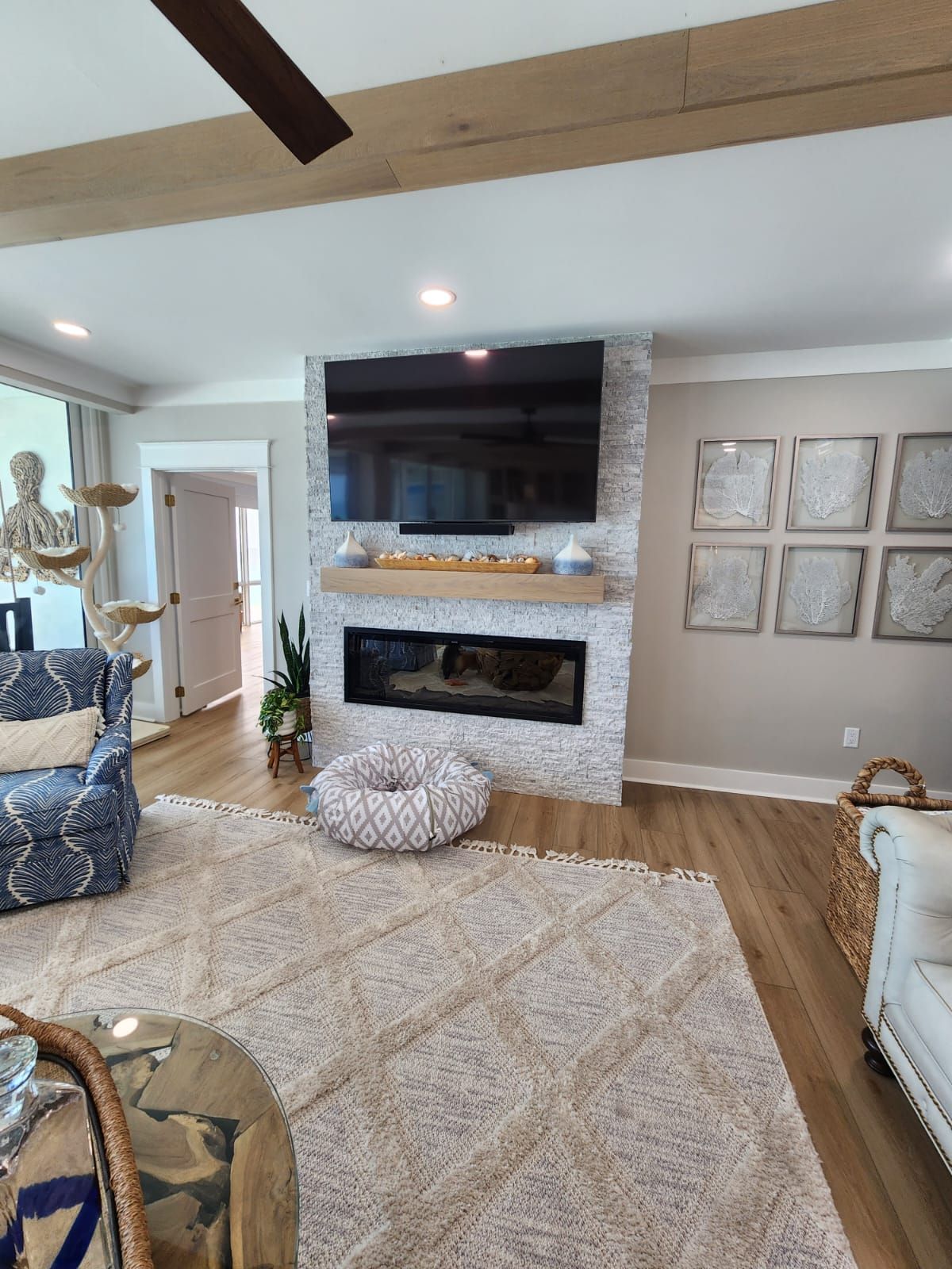 a living room with a fireplace and a flat screen tv .