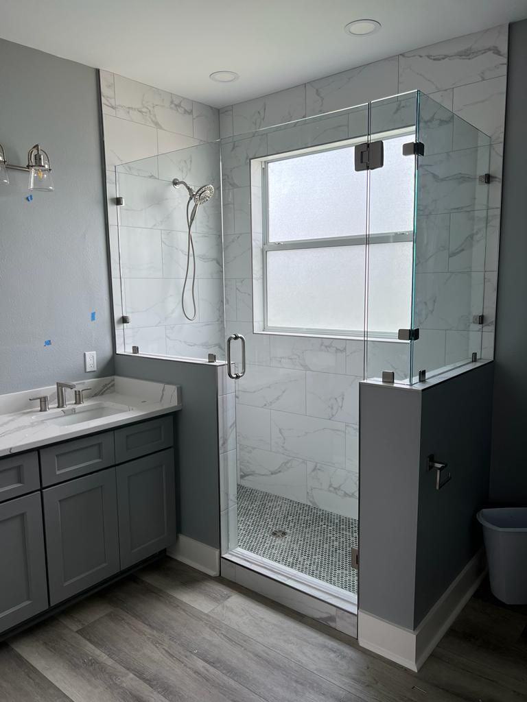 a bathroom with a walk-in shower and a sink