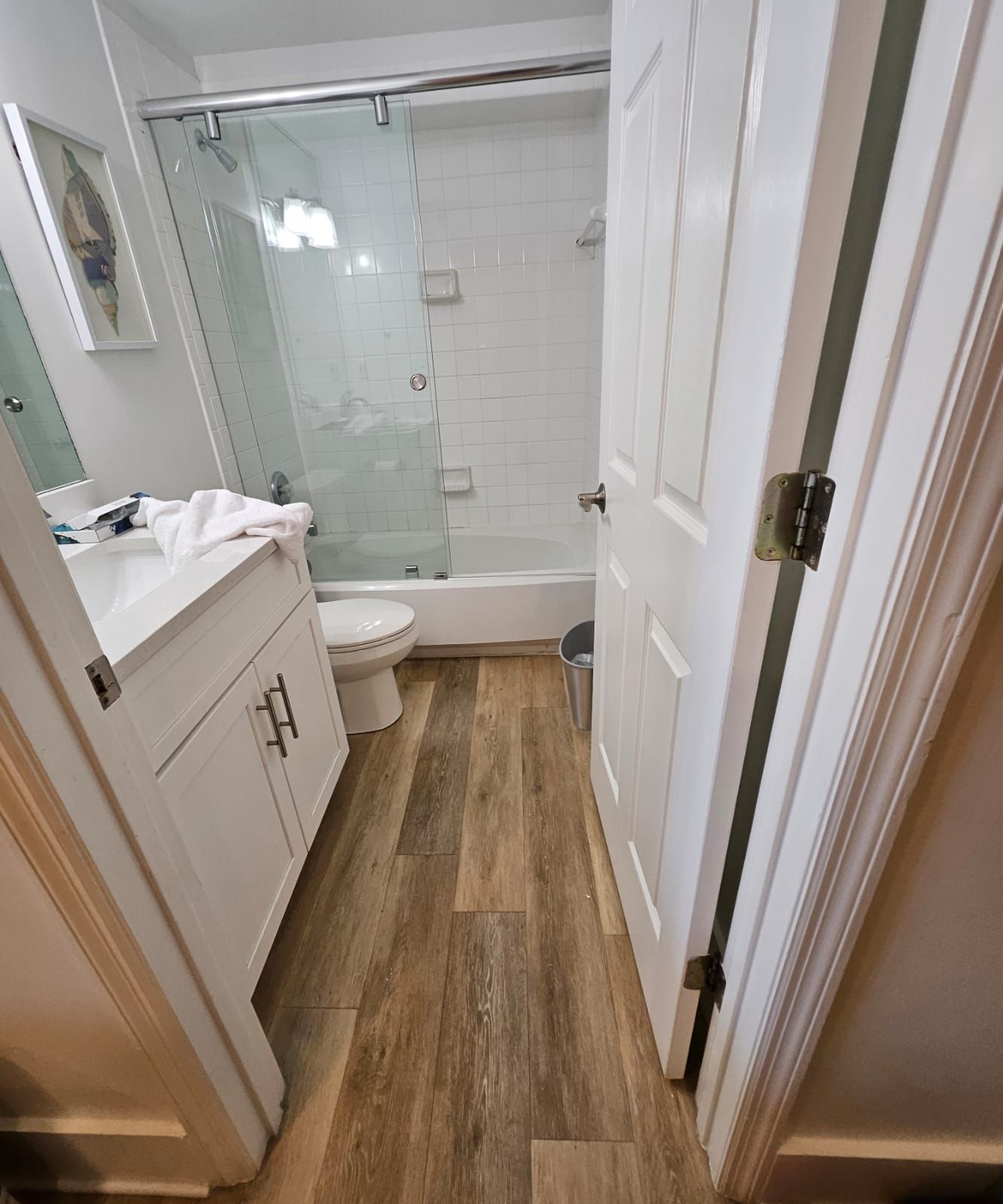 a bathroom with a toilet, sink, and shower
