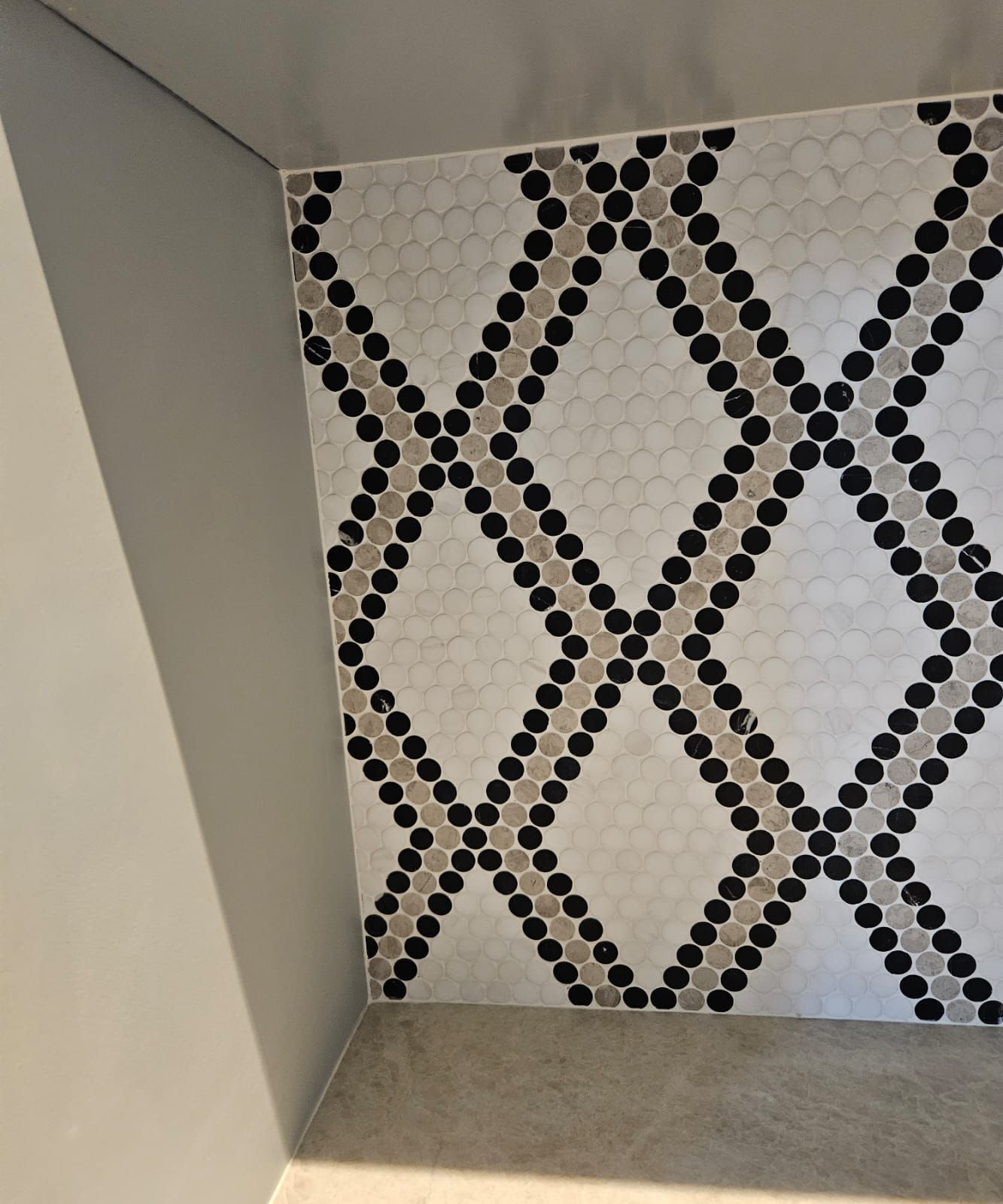 a black and white tile with a diamond pattern