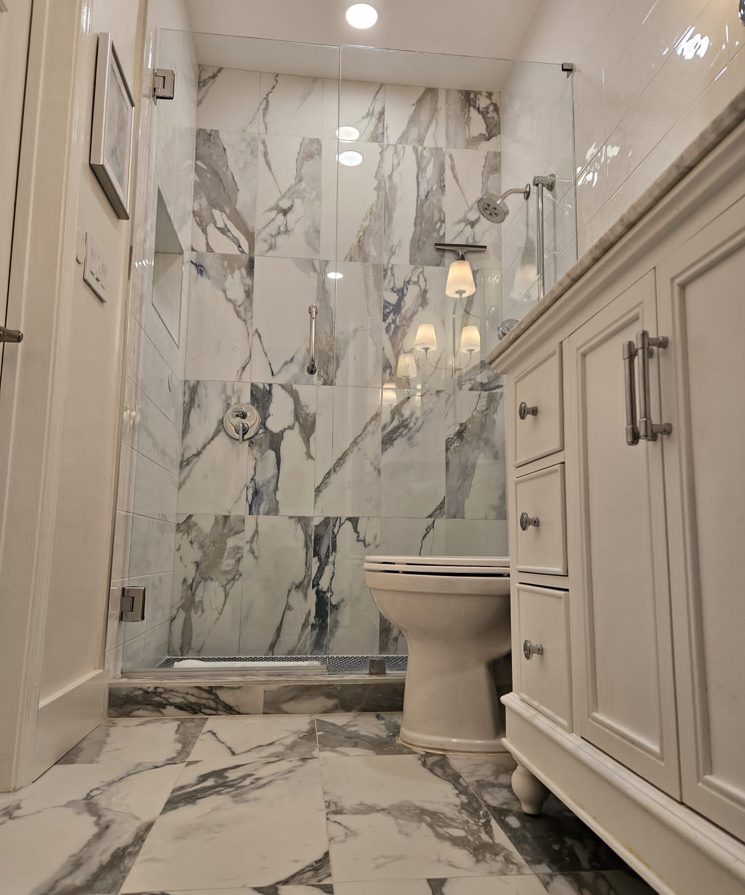 a bathroom with marble tiles and a toilet