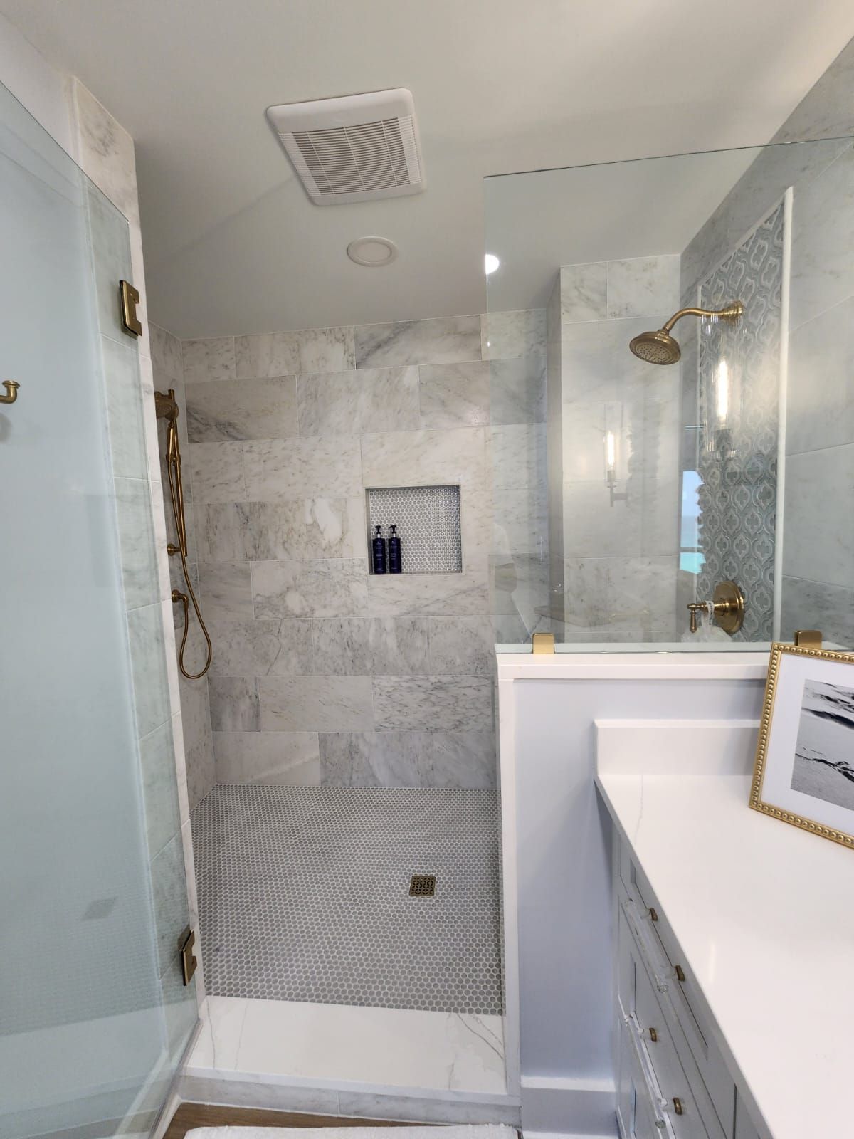 a bathroom with a walk-in shower and a mirror