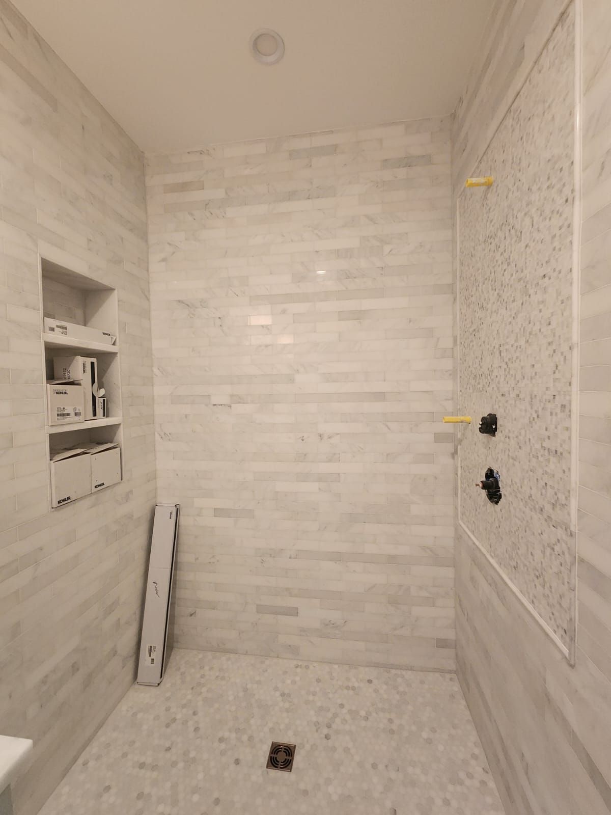 a bathroom with a walk-in shower and a sink