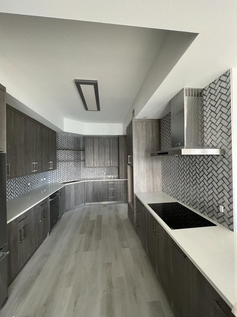 a kitchen with stainless steel appliances and wooden cabinets
