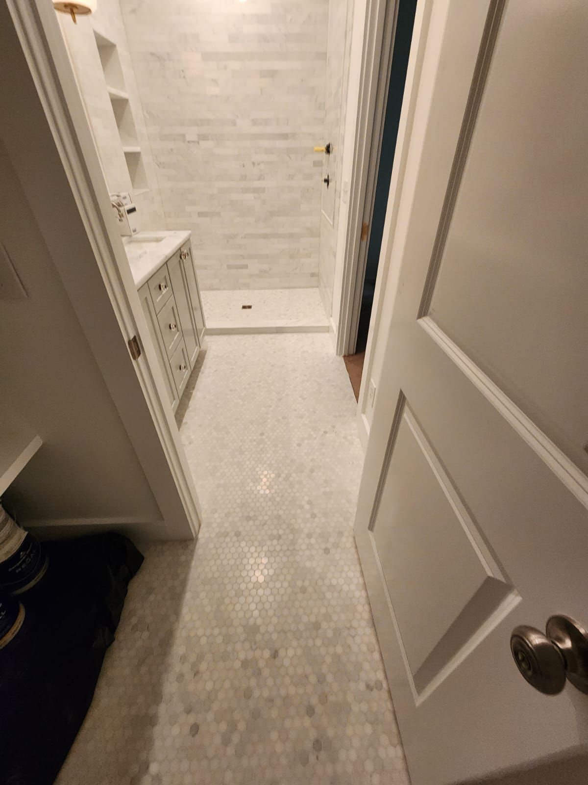 a bathroom with a walk-in shower and a sink