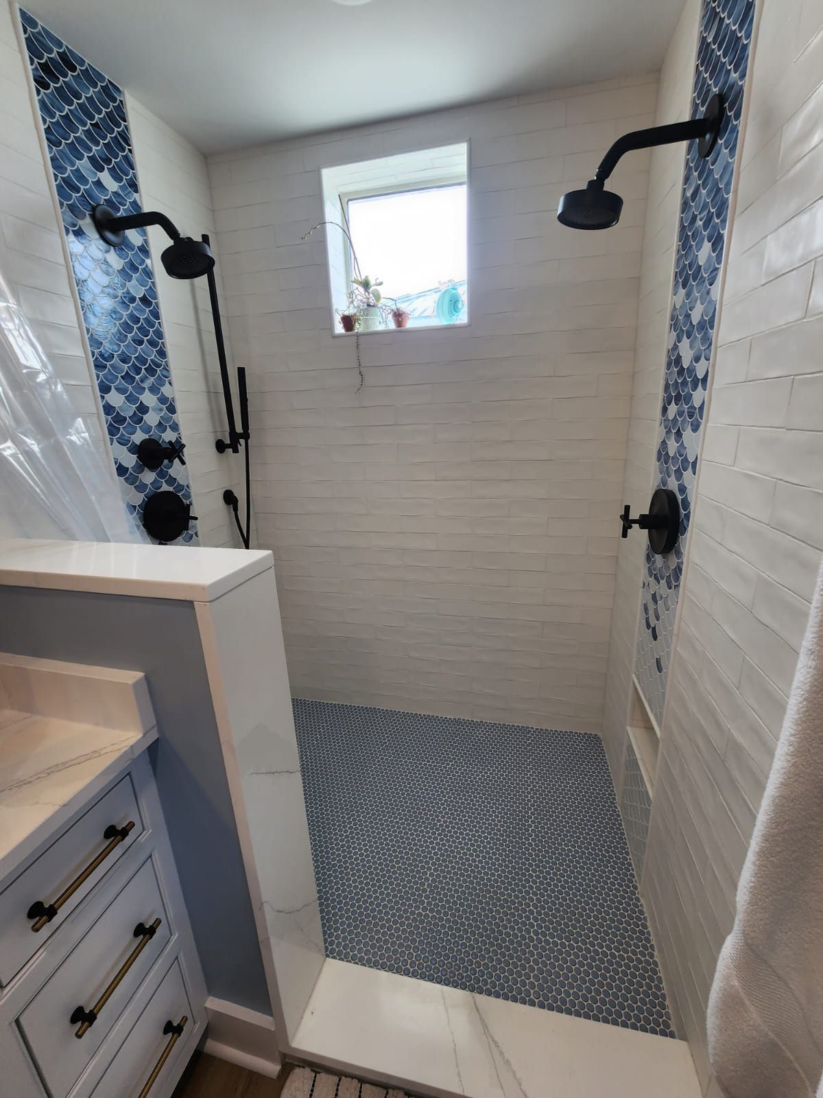 a bathroom with a walk-in shower and a sink