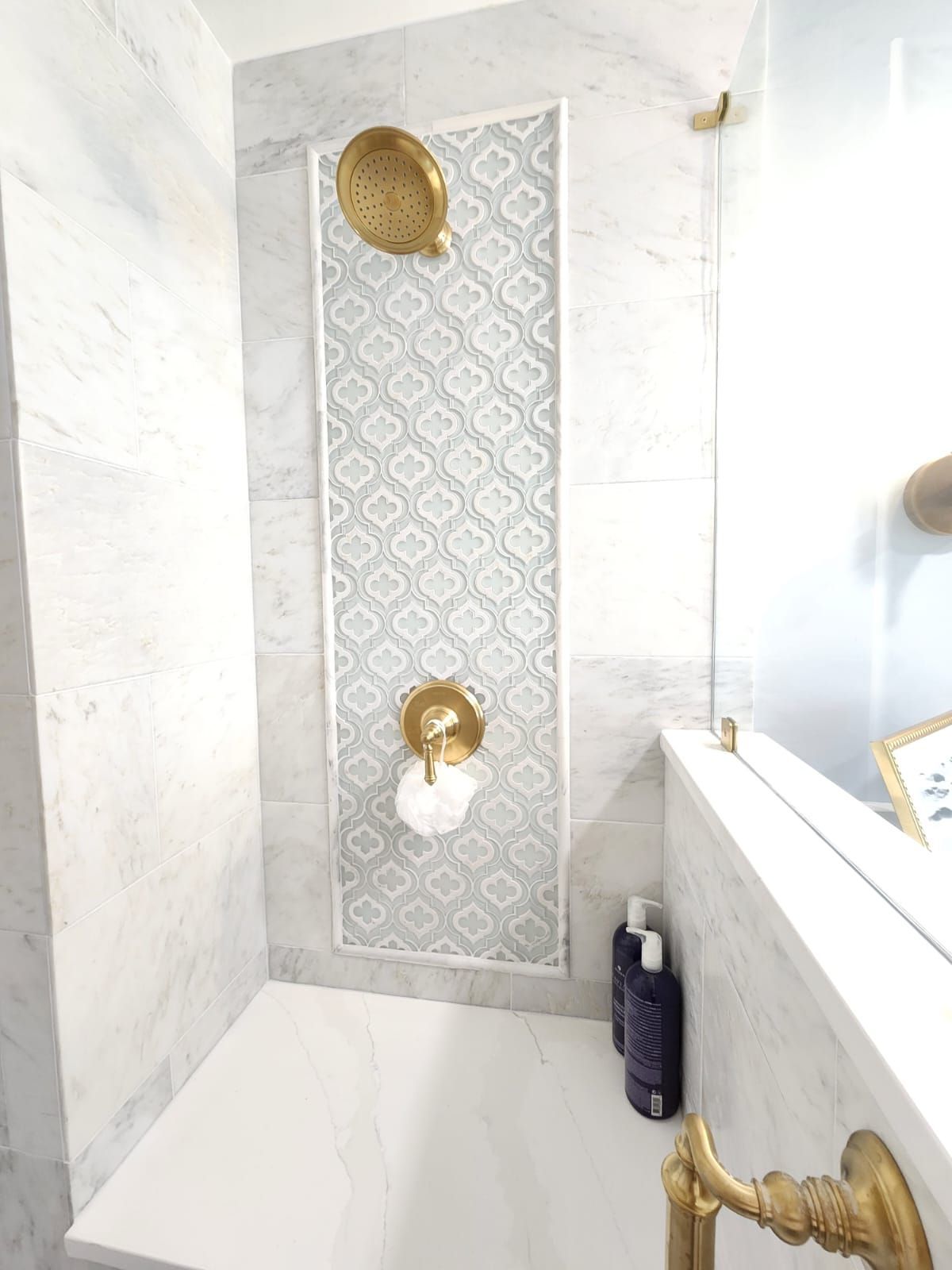 a bathroom with a walk-in shower and a mirror