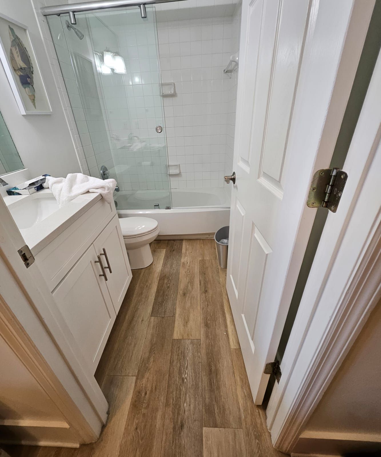 a bathroom with a toilet, sink, shower and bathtub