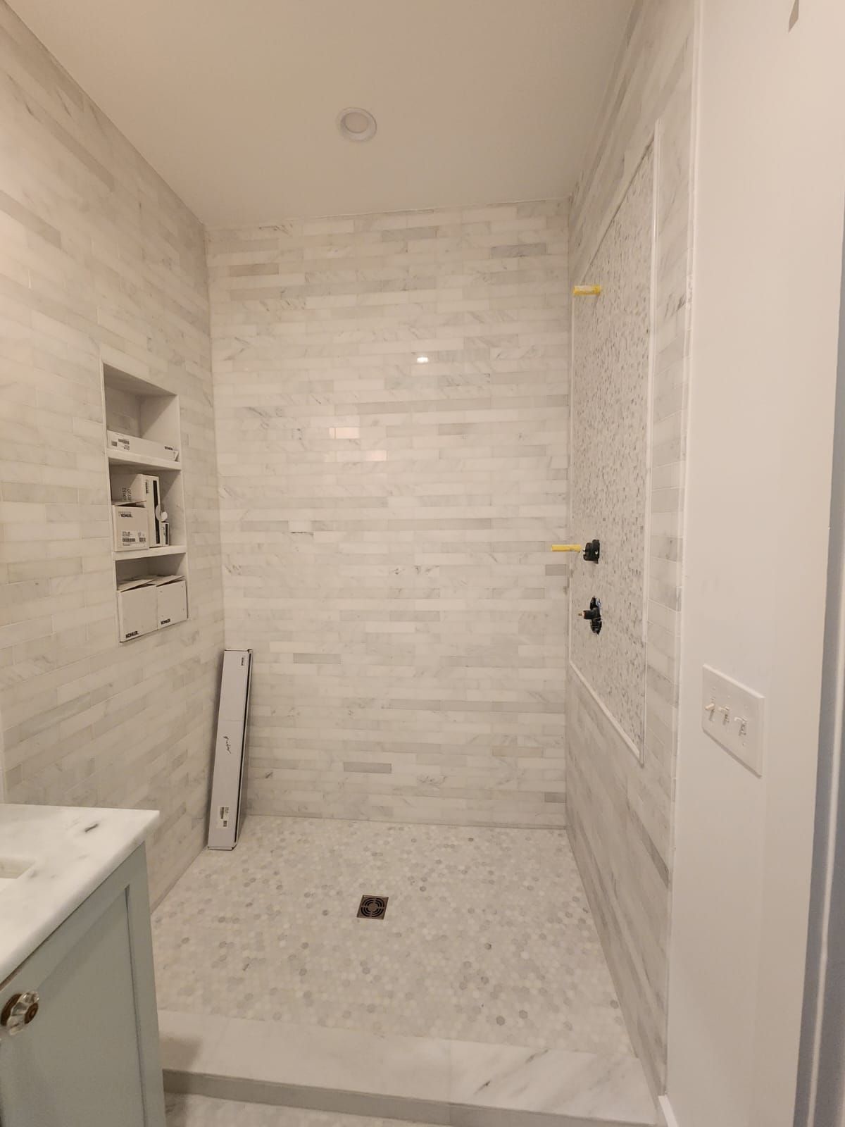 a bathroom with a walk-in shower and a sink