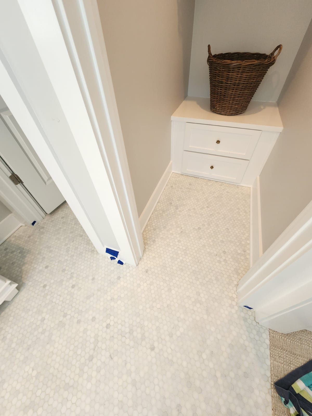 a laundry room with a basket on top of a dresser