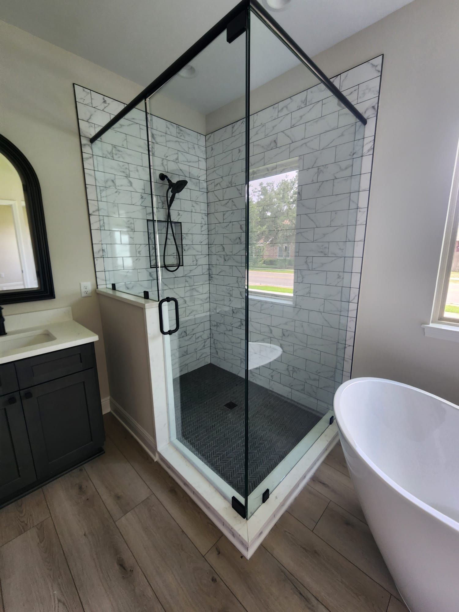 a bathroom with a walk-in shower and a bathtub