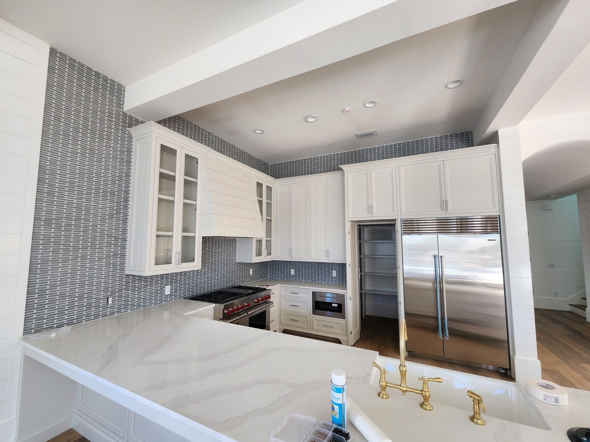 a kitchen with white cabinets and stainless steel appliances