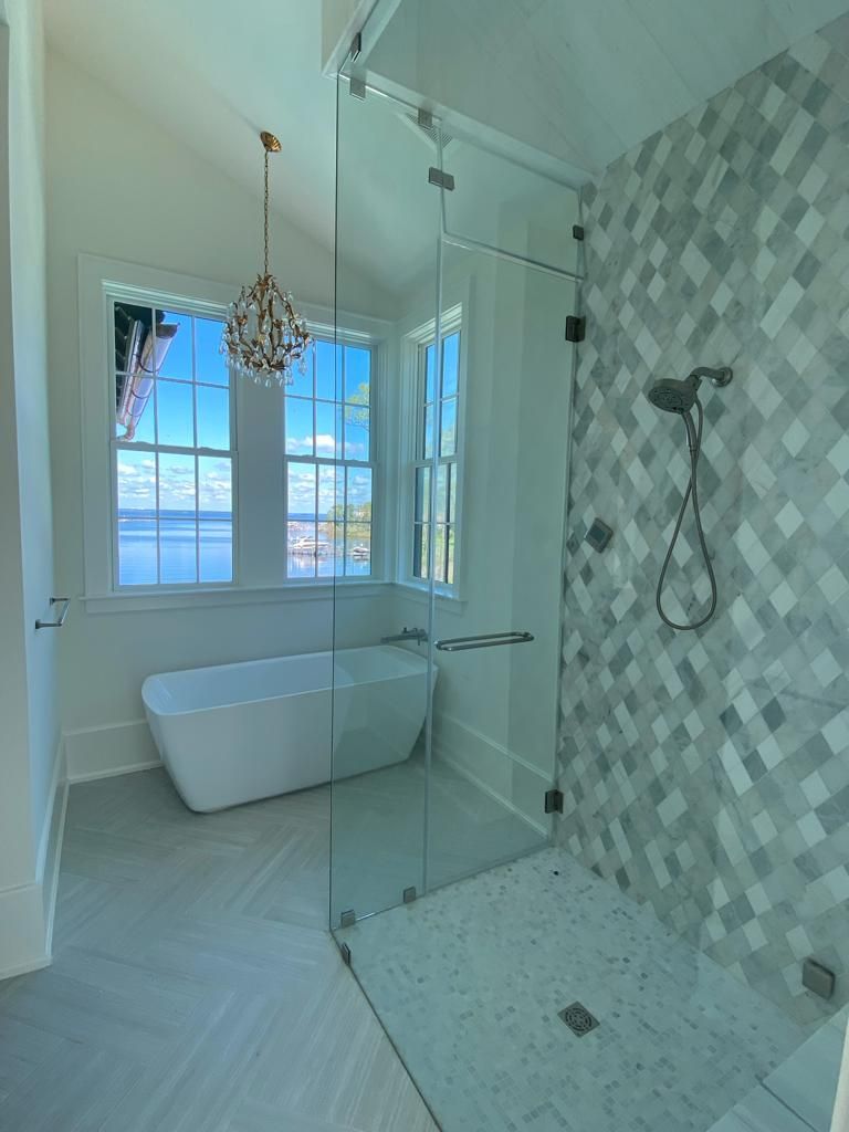 a bathroom with a bathtub and a walk-in shower