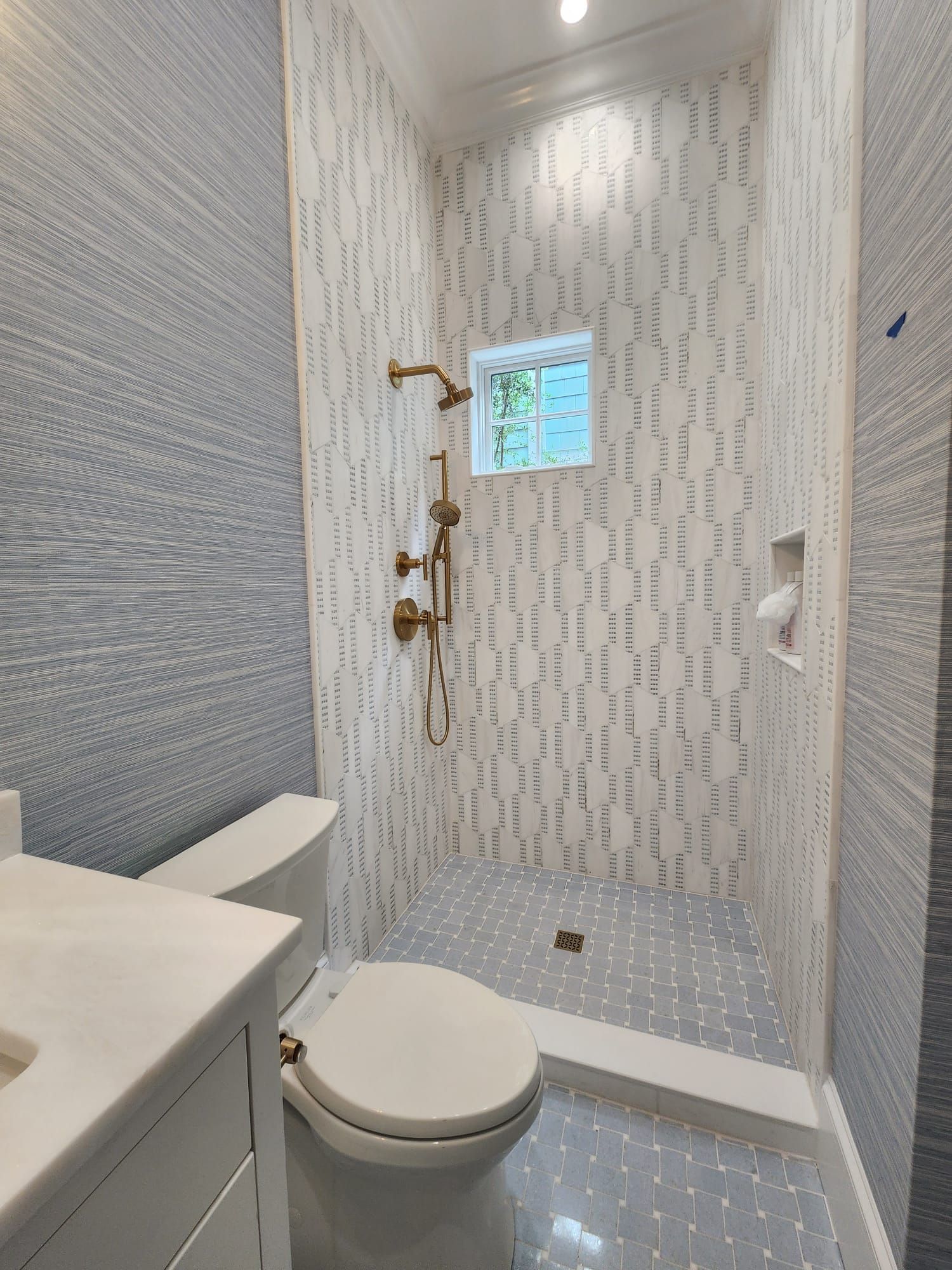 a bathroom with a toilet, sink, and shower