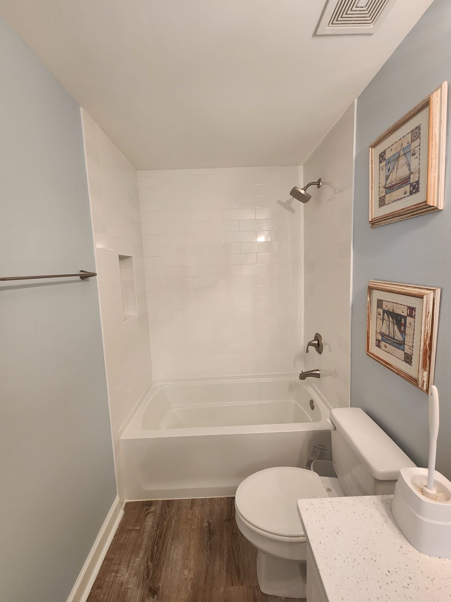 a bathroom with a toilet, bathtub, and shower