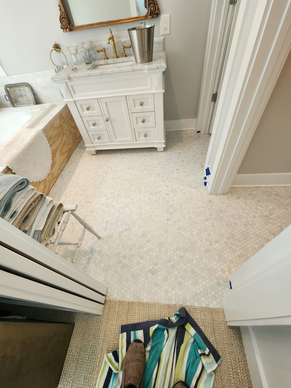 a person is standing on a towel in a bathroom next to a sink