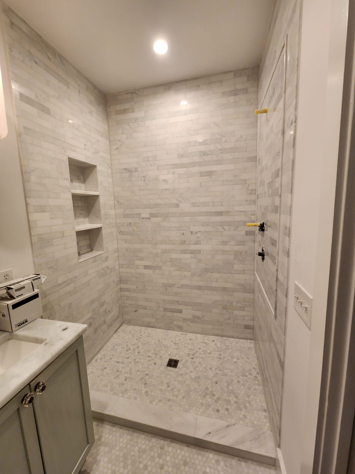 a bathroom with a walk-in shower and a sink