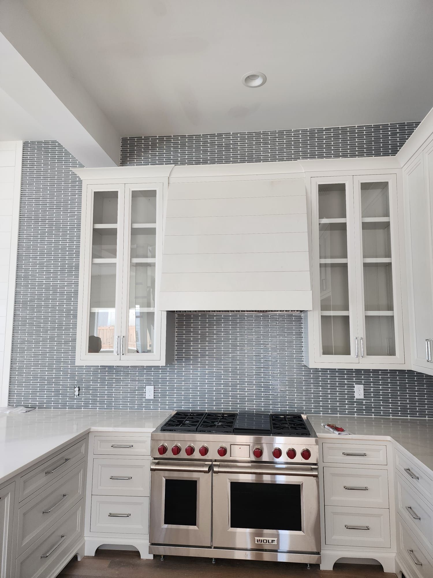 a kitchen with stainless steel appliances and white cabinets