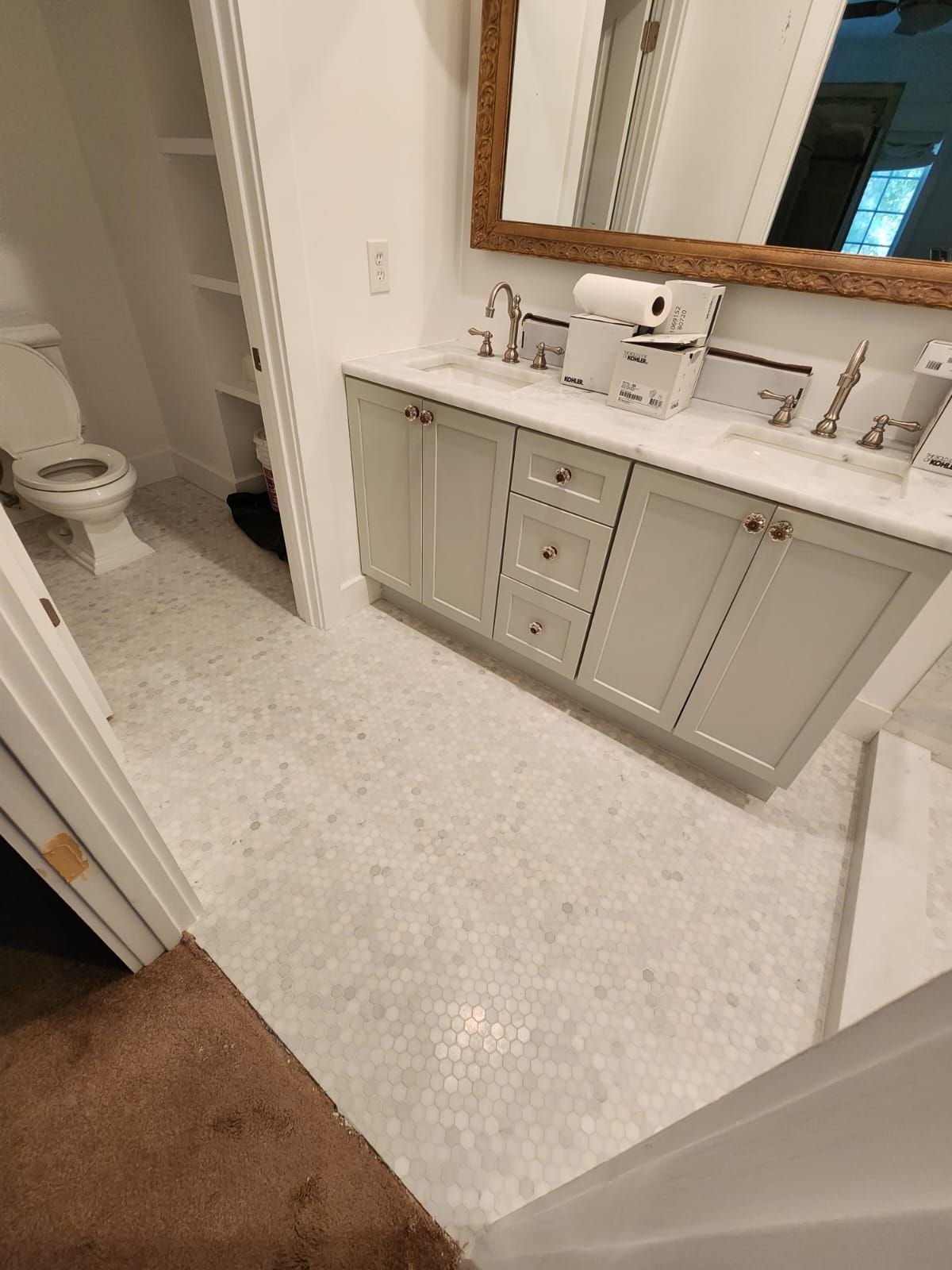 a bathroom with a sink, toilet and mirror