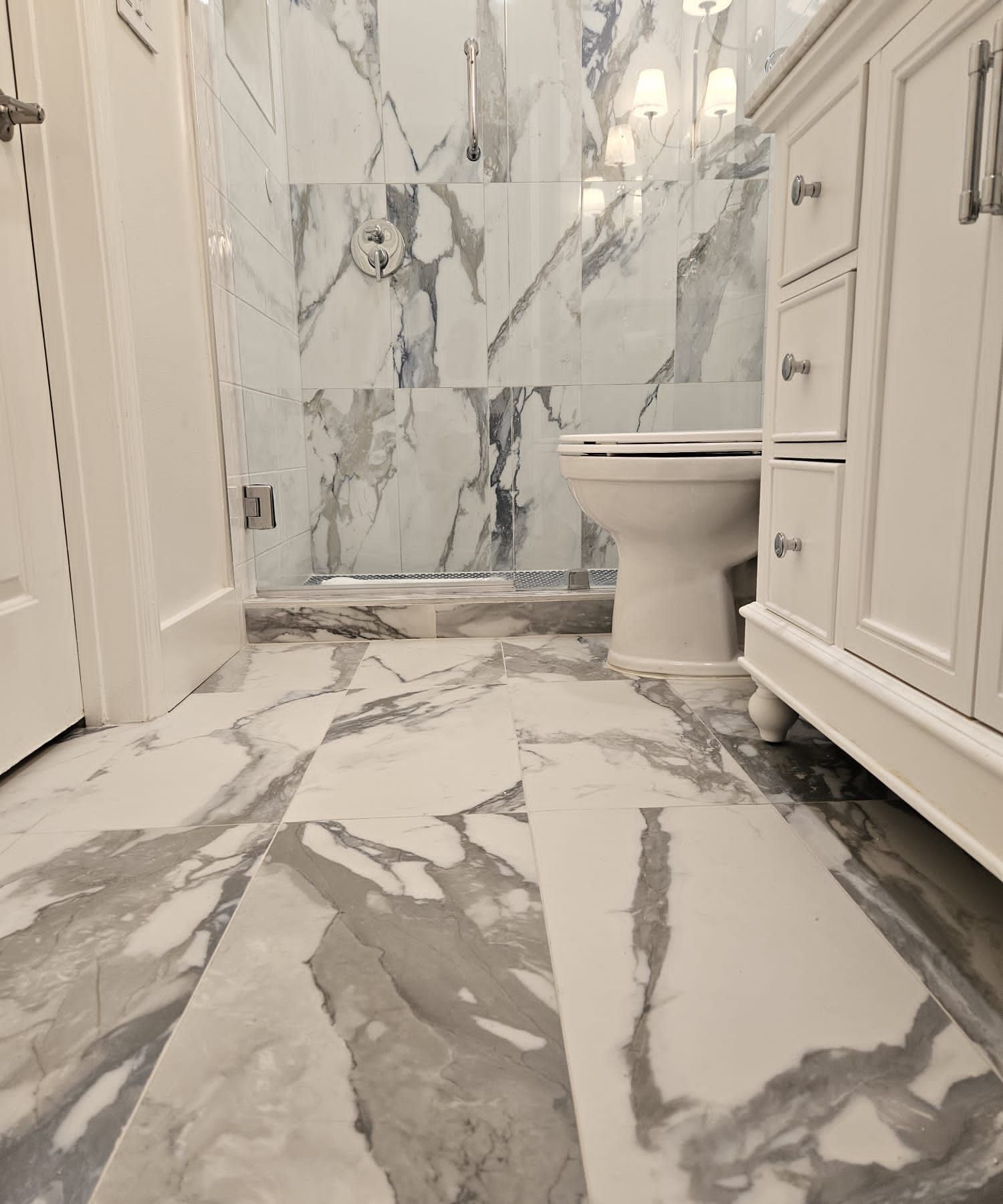 a bathroom with marble floors and a toilet