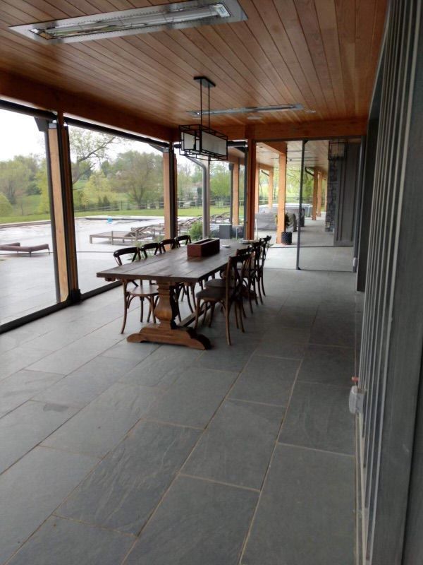 A dining room with a large table and chairs