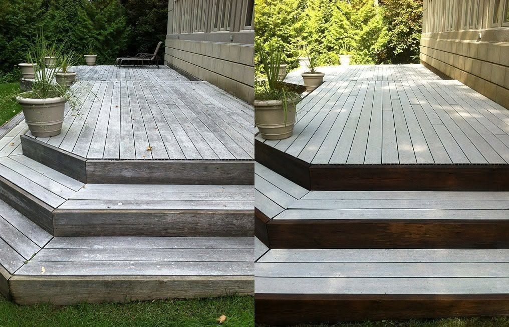 Wooden deck with split-level steps and potted plants beside a house
