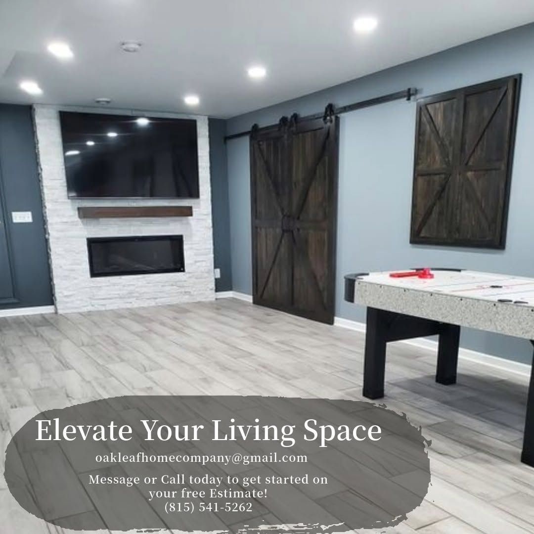 Modern gray living room with white brick fireplace, dark barn doors, and a pool table under the text “Elevate Your Living Space”