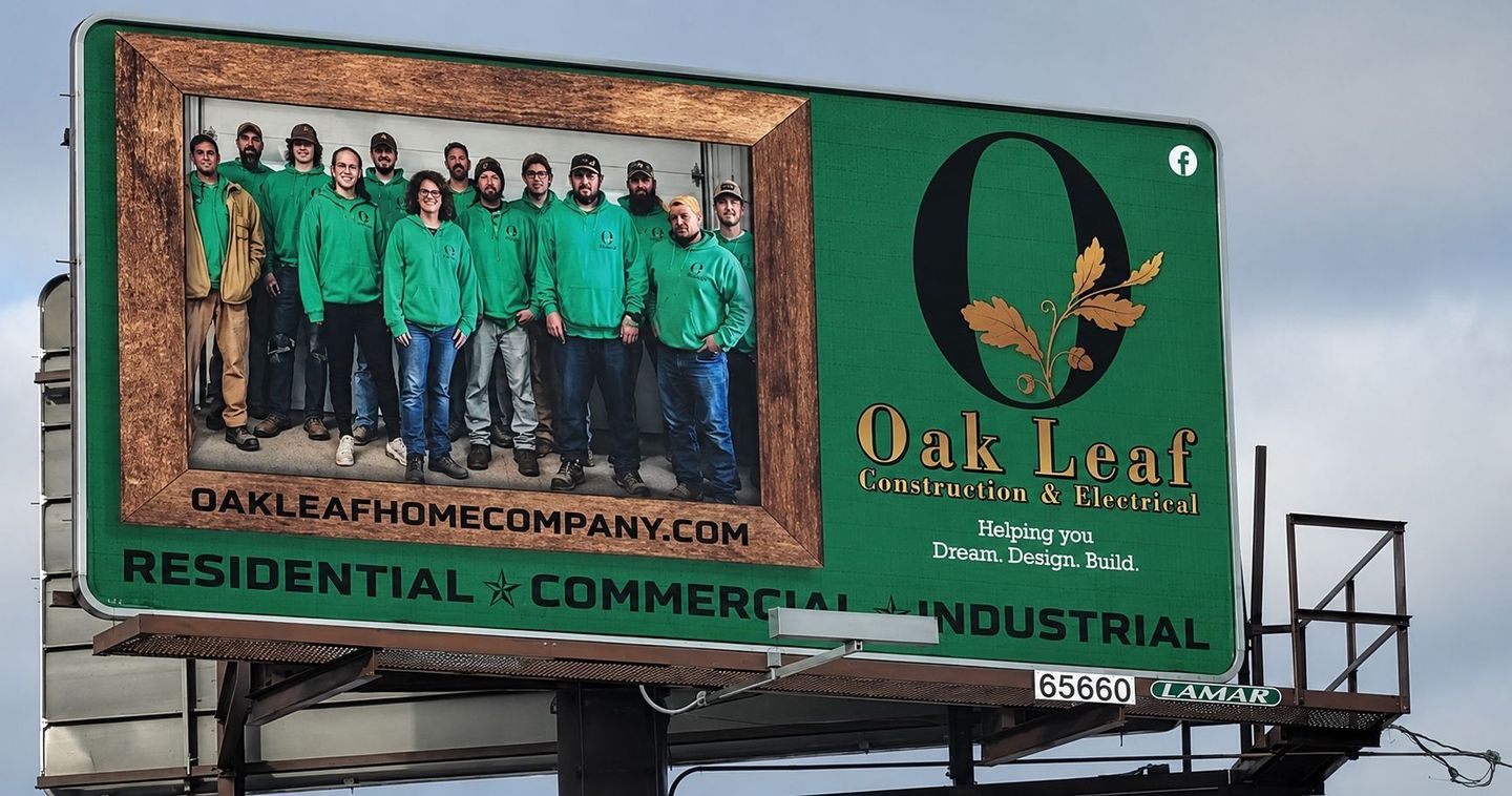 Billboard for Oak Leaf Home Co. with green-clad workers