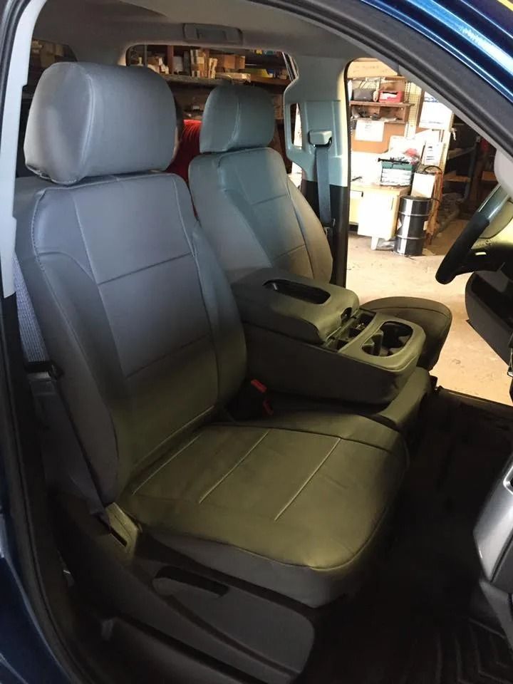 Gray car seat covers in a blue vehicle interior.