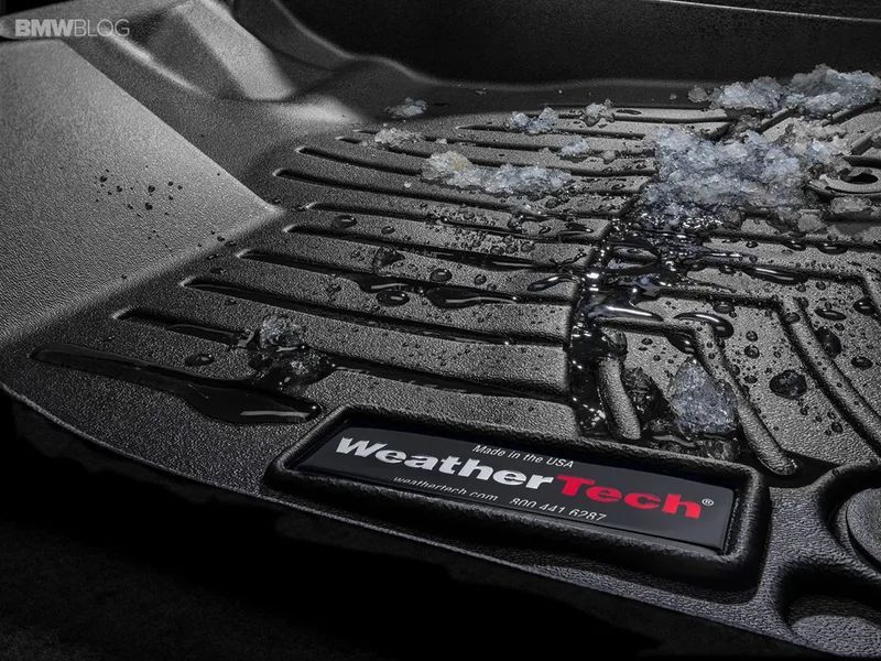 Black WeatherTech floor mat with melted snow and water.