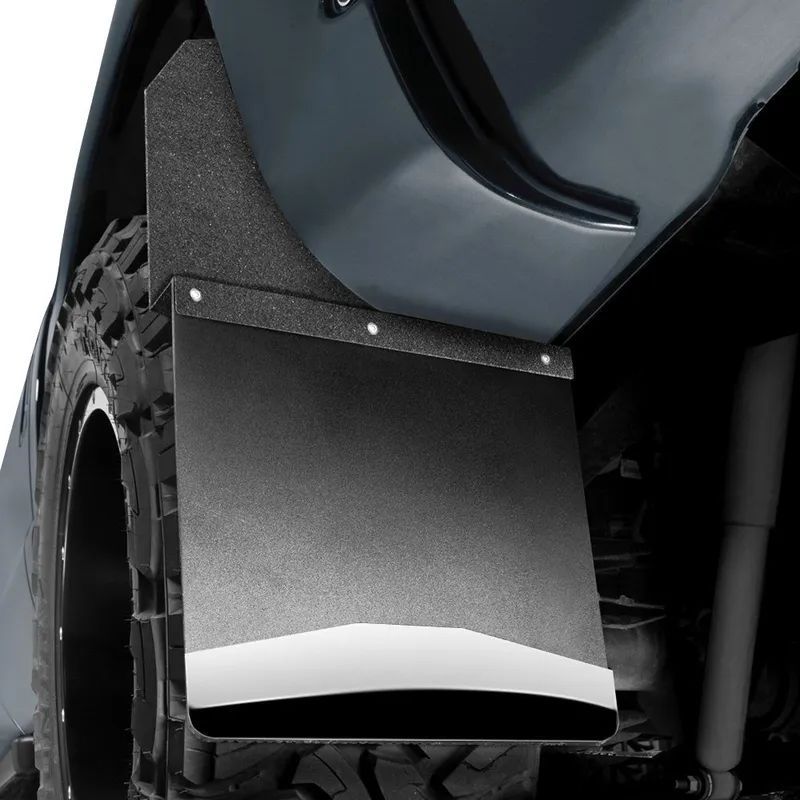 Black mud flap attached to a gray vehicle, near a tire.