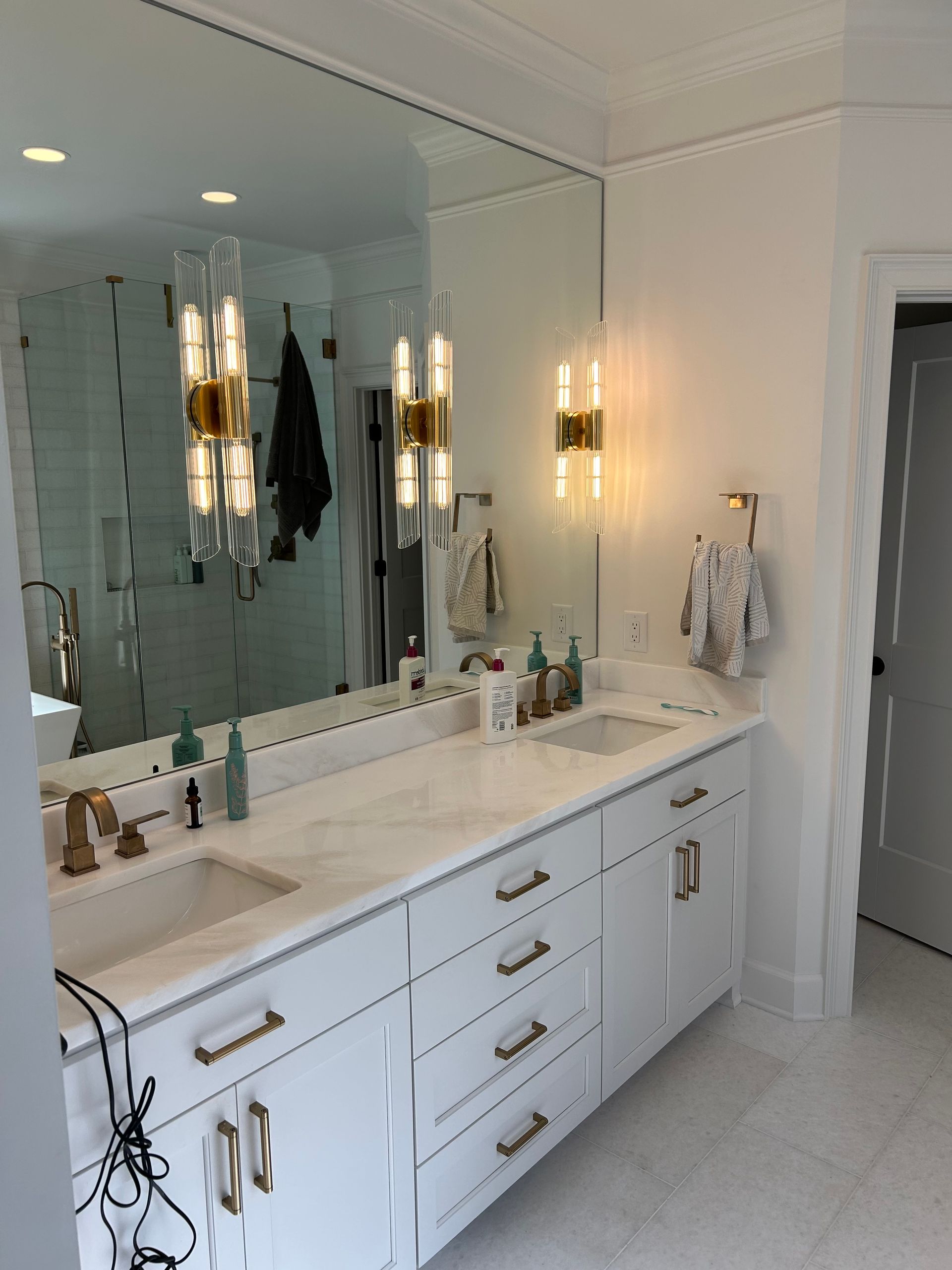 A bathroom with two sinks and a large mirror
