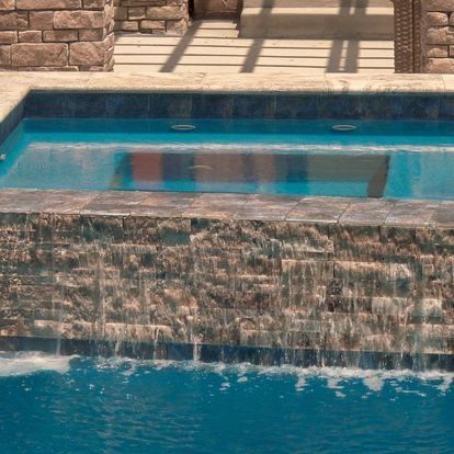 There is a waterfall in the middle of the pool.
