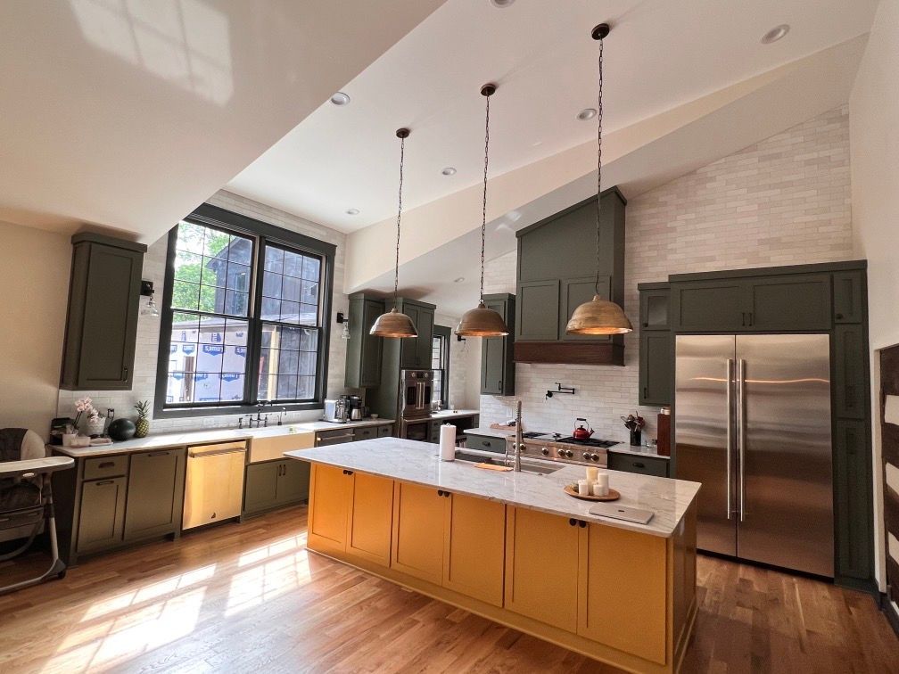 A kitchen with a large island and stainless steel appliances.