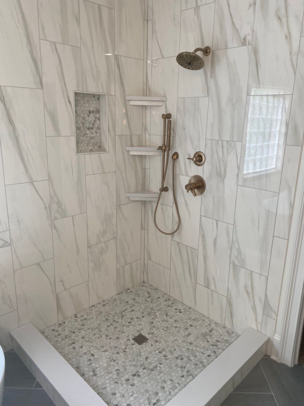 A bathroom with a walk-in shower