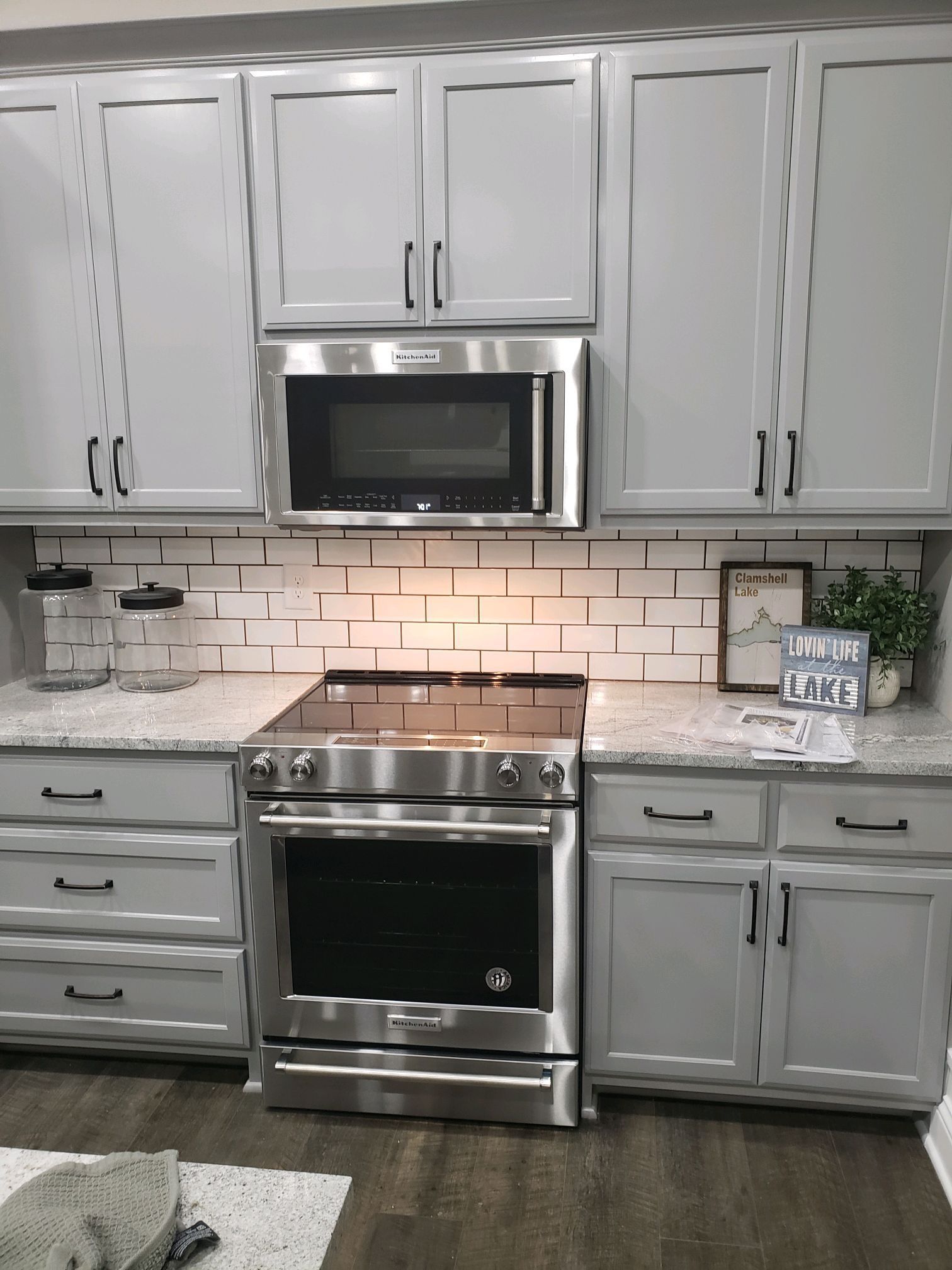 A kitchen with stainless steel appliances and white cabinets