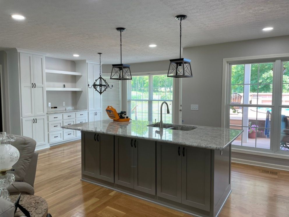 A kitchen with a large island and a sink.