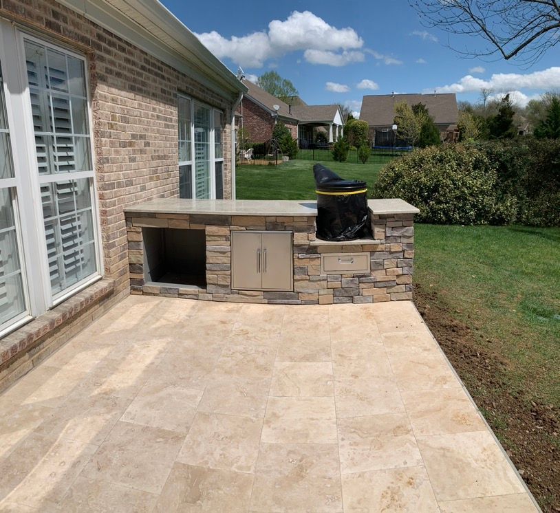 A brick house with a patio and a grill